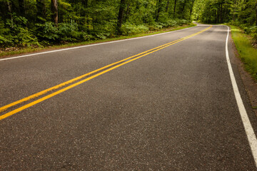 Scenic Highway K disappears around the turn in Vilas County, Wisconsin in late August