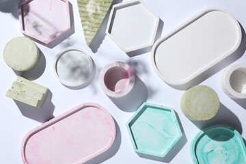 Set of Decorative pink plaster trays of different shapes on white background with shadows. Stands for candles organizers for cosmetics or jewelry. Top view
