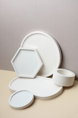 Decorative plaster trays on beige background. Stands for candles, organizers for cosmetics or jewelry.