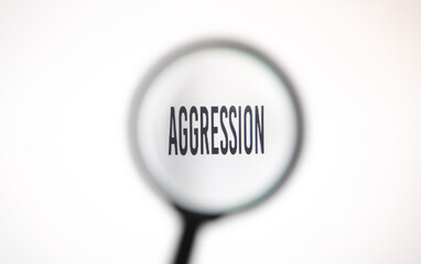 Word aggression on screen through magnifying glass close-up
