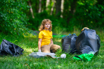 Global environmental pollution. Child collects plastic trash outdoor. The concept of environmental conservation. Kid putting household waste into bin bag. Eco kids volunteer. Pollution environmental.