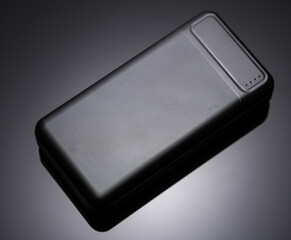 Black power bank, external battery on a black background