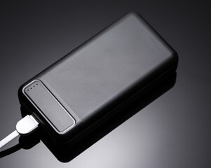 Black power bank, external battery on a black background