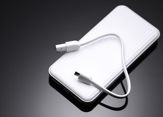 White power bank, external battery on a black background