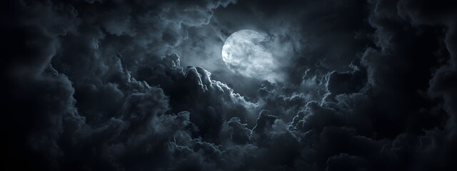 Fototapeta premium In the dark night, clouds in front of moonlight, creating an eerie atmosphere. The clouds form intricate patterns that resemble shadows and designs from darkness