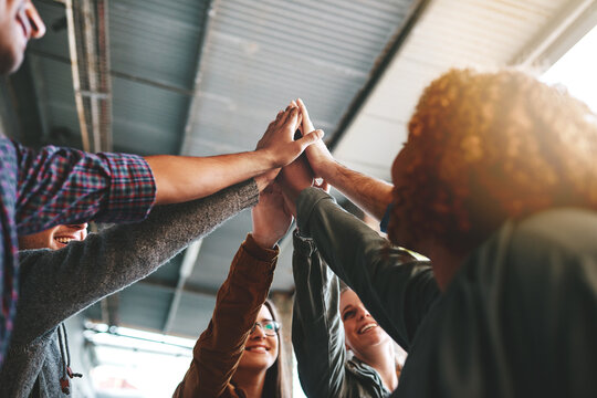 Group, students and high five with people, happy or excited in celebration for diversity at college. Friends, men and women in scrum, circle and synergy for education, learning or inclusion in Canada