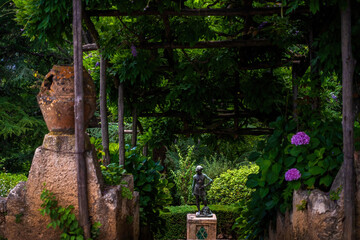 Serene Garden Scene with Statue and Green Foliage