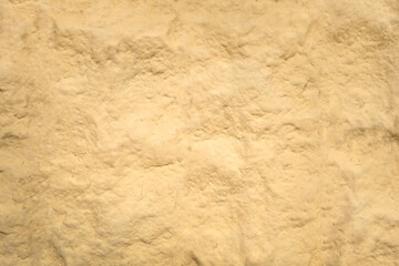 Warm beige rough flat lay surface, warm beige background