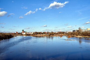 Fototapeta premium Historic buildings and towers of the gothic cathedral on the Warta River in the city of Poznan