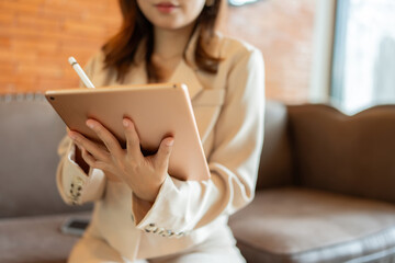 The female executive’s laptop was her primary tool in the office, where she meticulously managed...