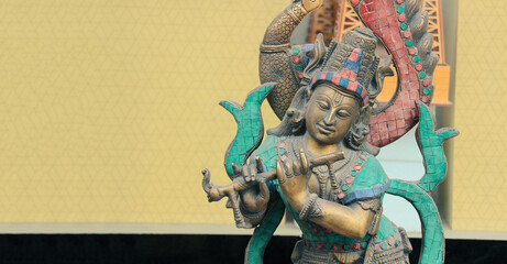 Krishna with flute. Hindu statuette.