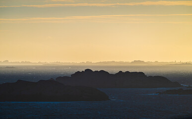 Fototapeta premium Sea haze in a rocky landscape at sunset.