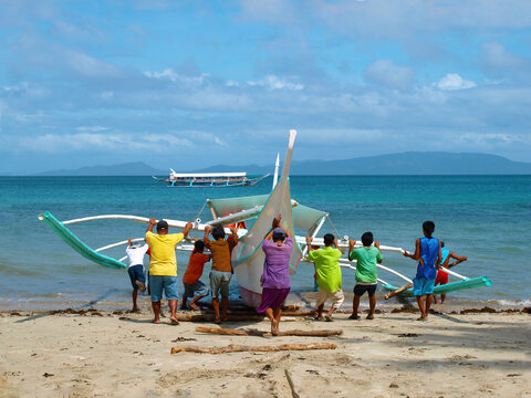 National Philippine boat. Filipino fishermen launch a traditional boat
