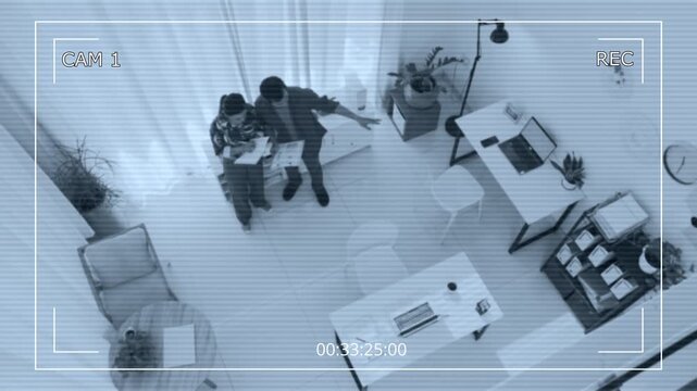 Surveillance camera shot of coworkers talking about their business in office of modern startup company