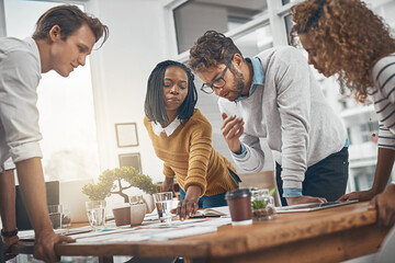 Brainstorming, group and planning with paperwork in office, creative and explaining of interior designer. Collaboration, employees and reading of floorplan, ideas and people in meeting for project