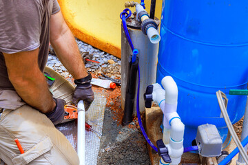 Water supply pipe made of PVC is being connected to pump house of an artesian well system