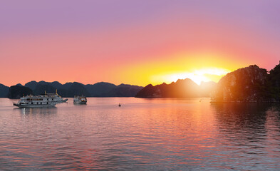Naklejka premium Sunset In The Morning On The harbour In Ha long Bay with fisboat - Vietnam