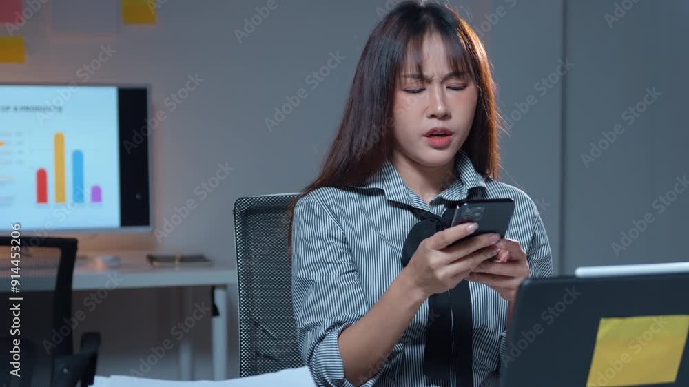 Aufkleber stressed office worker using phone and laptop in modern workspace with data charts in background. yo