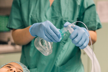 The application of a ventilation mask on a patient by a medical professional
