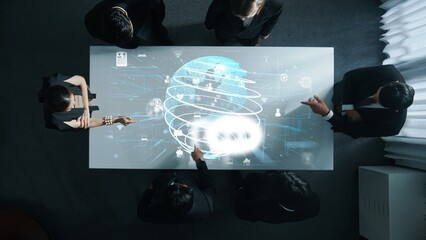 Top down aerial of business team brainstorm idea about digital communication or global network connection. Group of diverse business people discuss about data processing at meeting room. Directorate.
