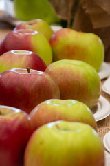 Close up of fresh apples in a bowl on plate on the table, harvest festival