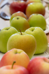 Close up of fresh apples in a bowl on plate on the table, harvest festival