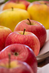 Close up of fresh apples in a bowl on plate on the table, harvest festival