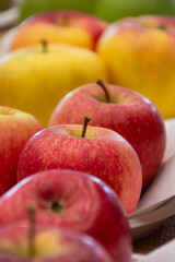 Close up of fresh apples in a bowl on plate on the table, harvest festival
