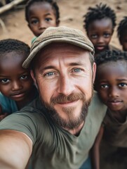 Fototapeta premium A man taking a selfie with a group of smiling children, great for family or social media use