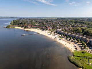 Aerial drone photo of the beach and the town named Huizen in the Netherlands