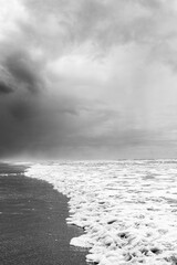 clouds on lonely beach with waves