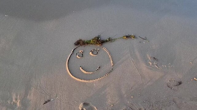 A CHARACTER DRAWN ON THE SEASHORE