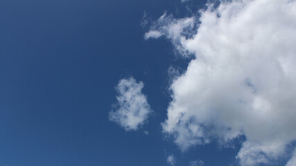 Clouds against a vivid blue sky on a summers day in June in the UK