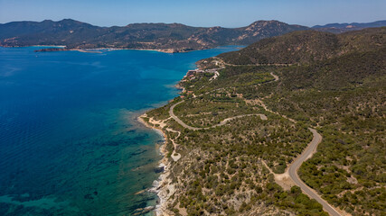 Italian panorama of a typical Sardinian coast with small mountains and roads © Tommaso