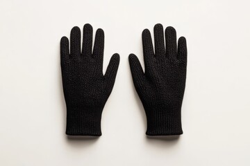 Top view of black knit gloves on white background