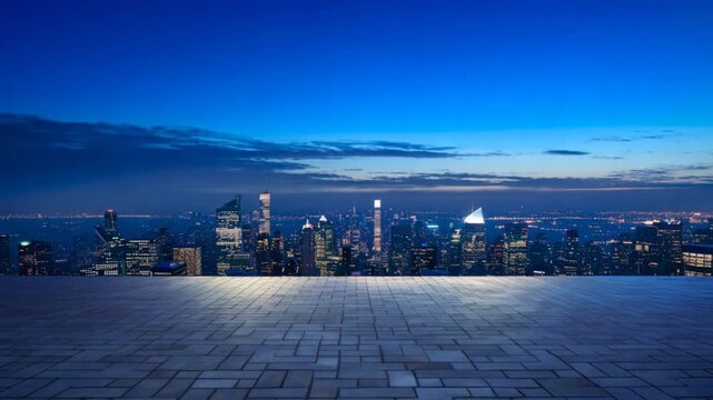 Empty view of empty concrete tile floor with big city skyline. Night scene.