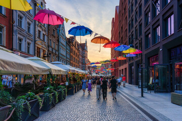 Colorful umbrellas on the street in Gdansk during the summer fair. Poland