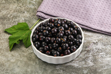 Ripe black currant in the bowl