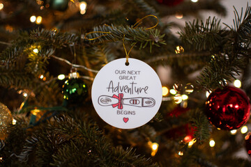 Pregnancy announcement decoration on a Christmas tree. Pregnancy concept. Christmas ornament on a tree pregnancy announcement 