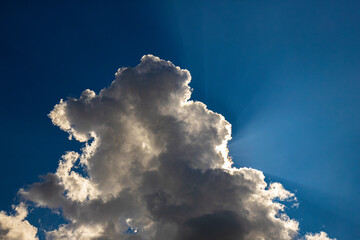 Close-up view of a splash in water, surrounded by concentric ripples and reflections of the sky....