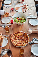 Friends, pizza and top view of restaurant table for brunch, birthday and celebration as outdoor event. Group of people, food and beer or wine at city pub for lunch, party and social reunion in Italy