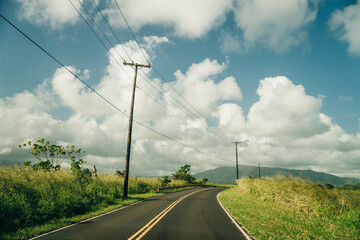 Highway through a lush tropical forest in kauai, hawaii - may 2023