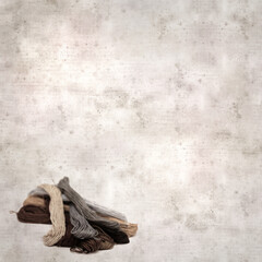 textured stylish old paper background, square, with cotton embroidery thread hanks in different...