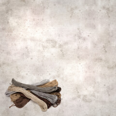 textured stylish old paper background, square, with cotton embroidery thread hanks in different...