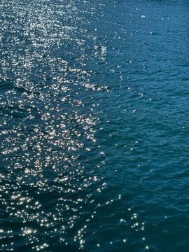 Blue glittering ocean water background