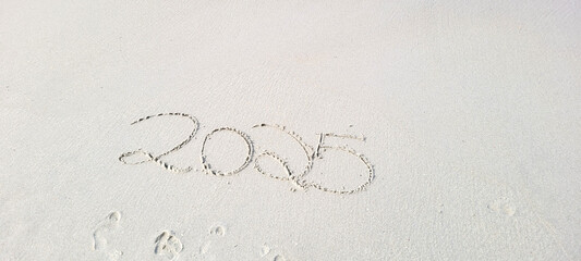 happy 2025 written in the sand of itamambuca ubatuba beach