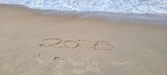 happy 2025 written in the sand of itamambuca ubatuba beach