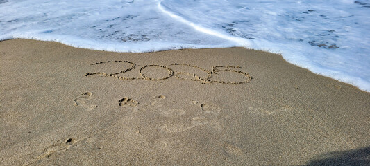 happy 2025 written in the sand of itamambuca ubatuba beach
