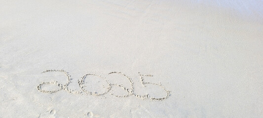 happy 2025 written in the sand of itamambuca ubatuba beach