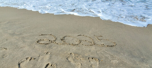 happy 2025 written in the sand of itamambuca ubatuba beach
